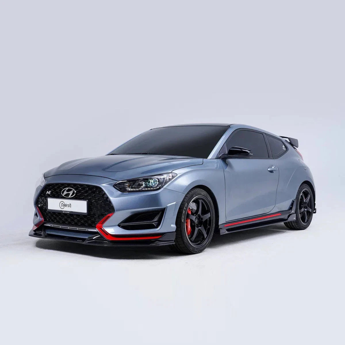Carbon fiber front lip, black with red accent line, front bumper corner view