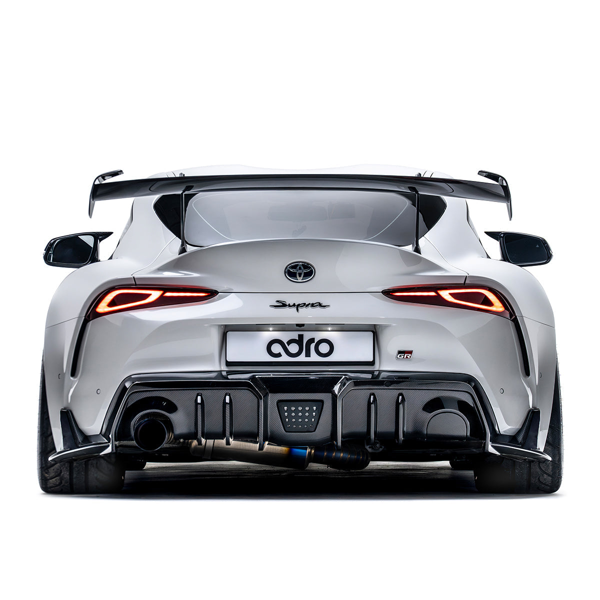 ADRO AT-R2 Taller Uprights on Toyota GR Supra, rear view showing custom carbon fiber accents installed.
