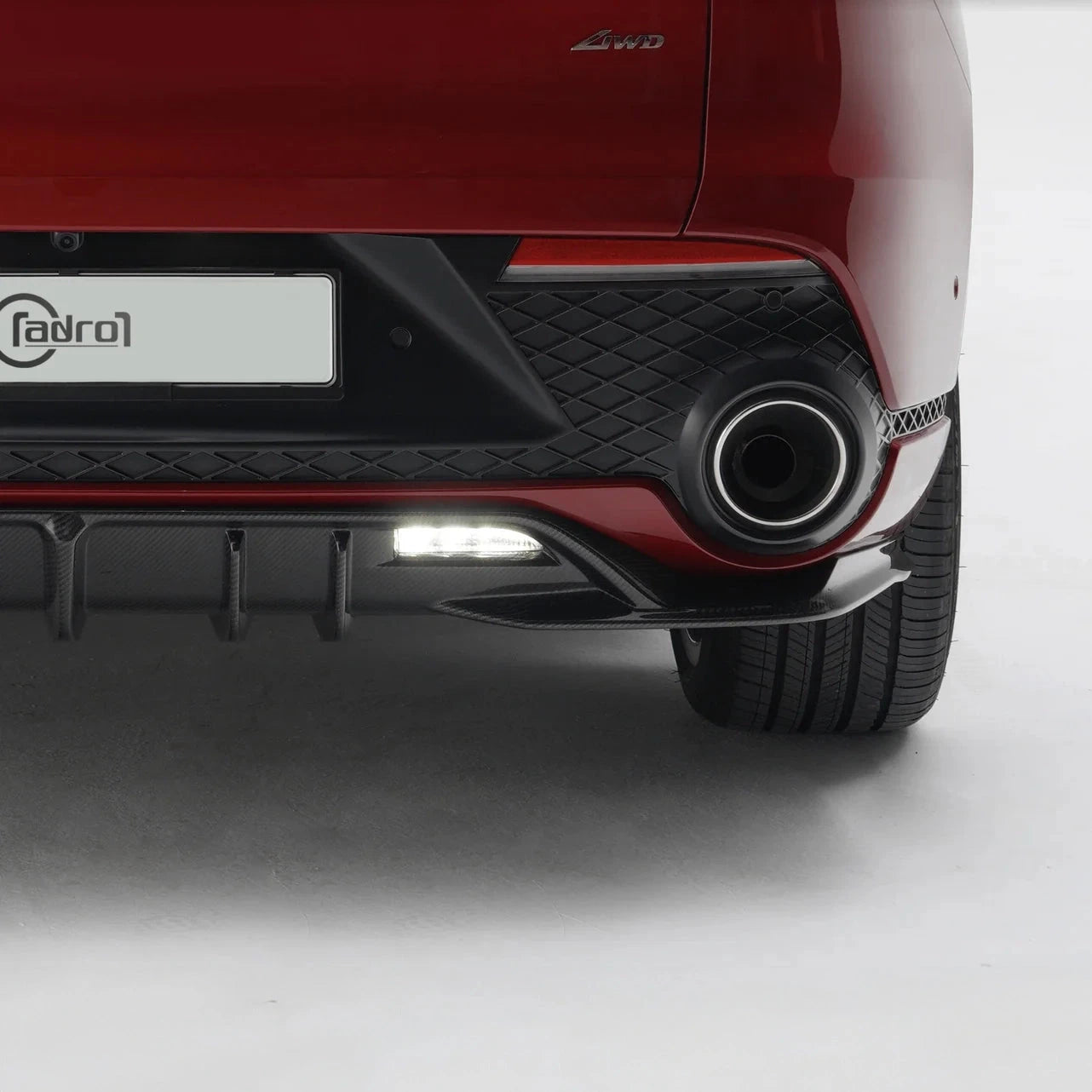 Rear diffuser side with black carbon-fiber style, oval exhaust outlet, and fins