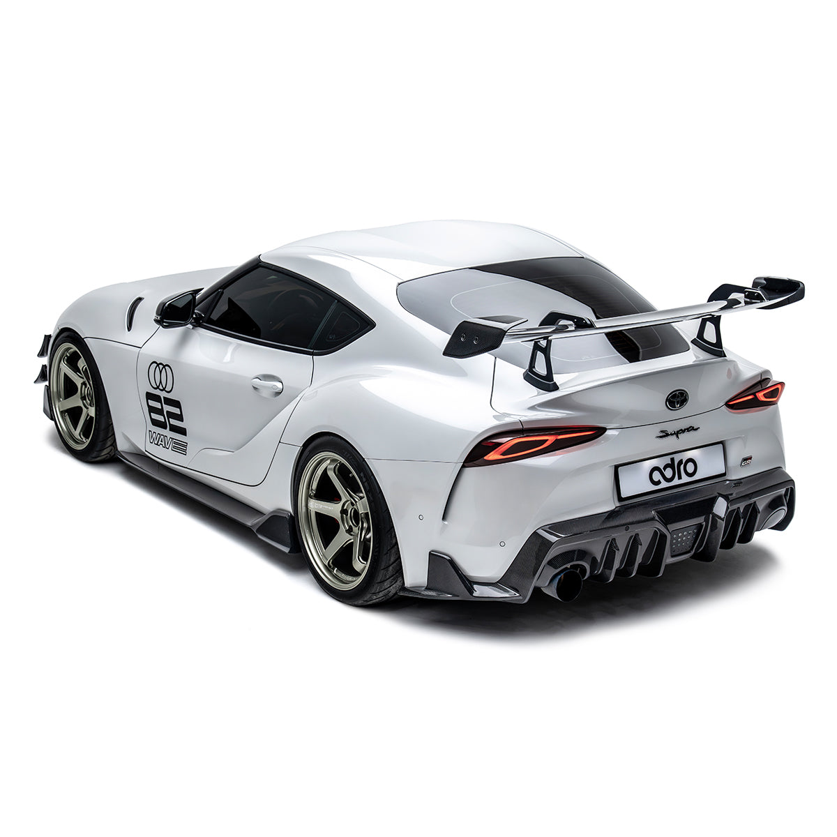 ADRO rear wing and carbon diffuser on Toyota GR Supra AT-R2, rear three-quarter view.