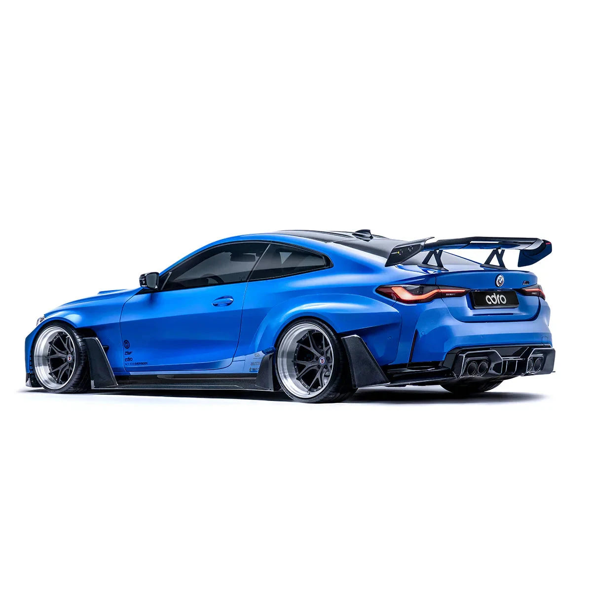 ADRO wide-body kit and AT-R3 Swan Neck Wing V1 on BMW G80 M3, rear side view.