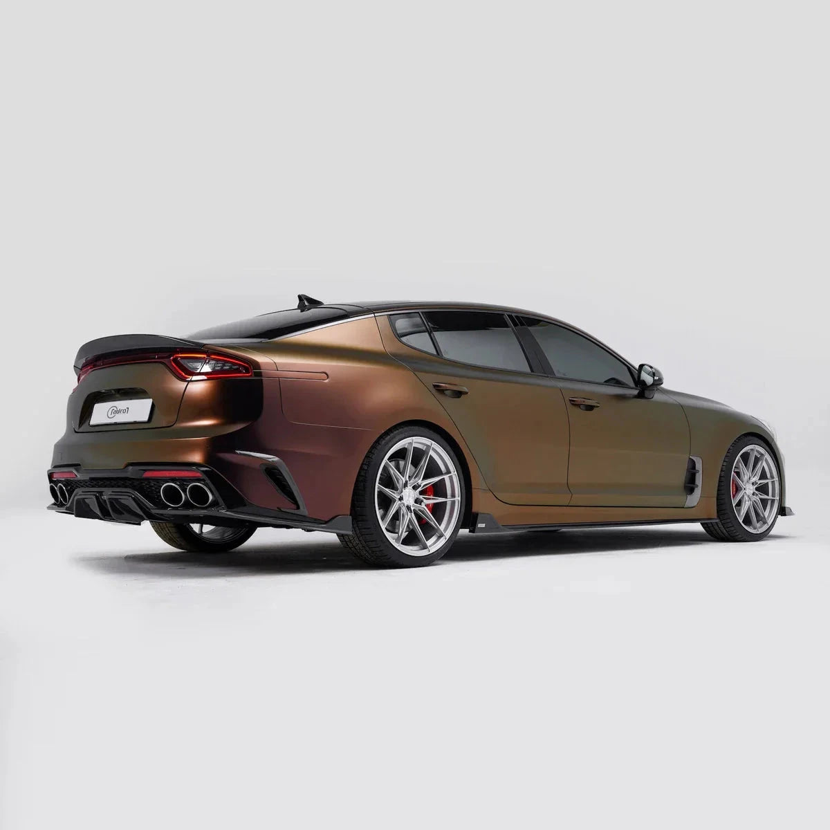 ADRO carbon fiber rear diffuser V3 on Kia Stinger CK, rear three-quarter view in white studio.
