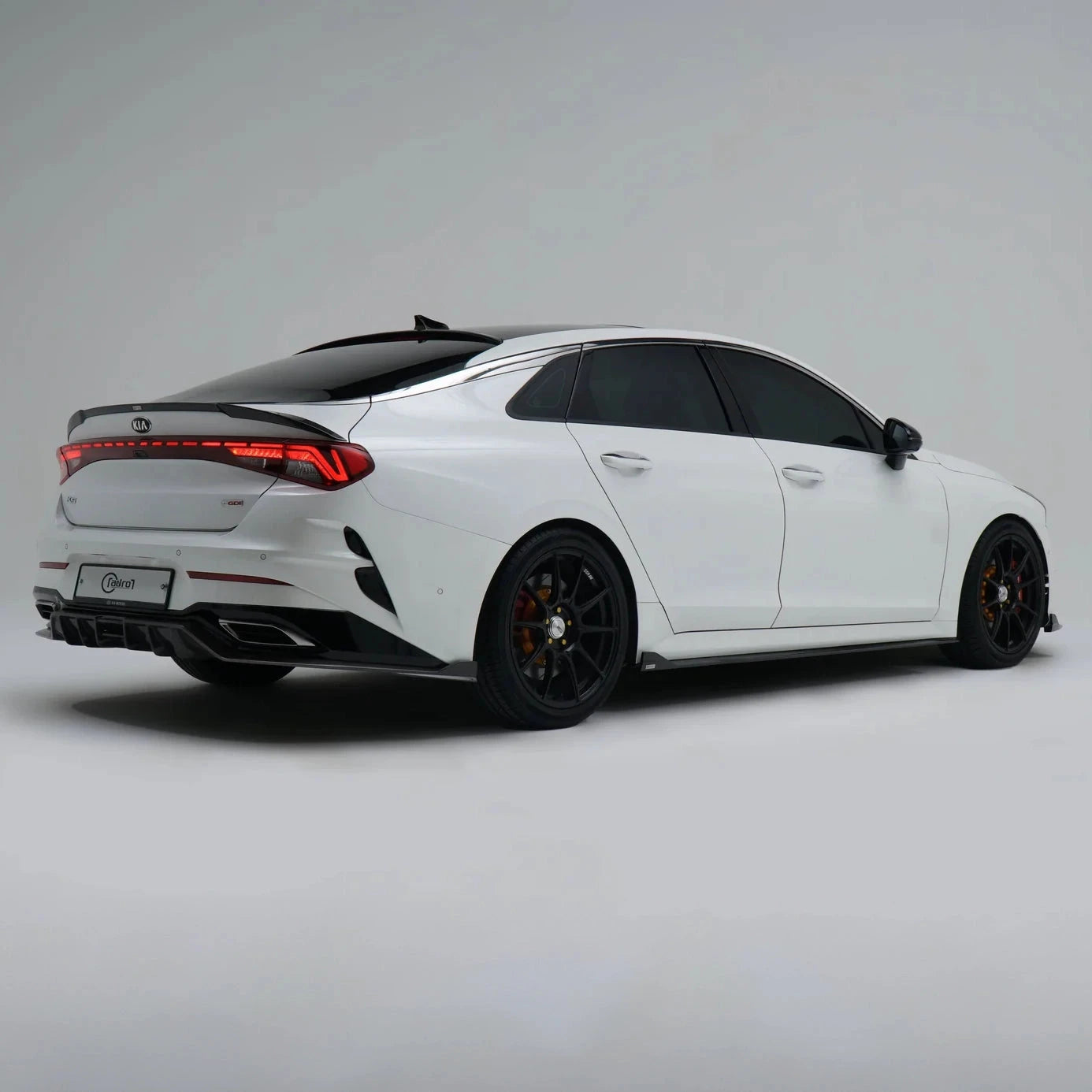 KIA K5 carbon fiber side skirt, black rocker trim on rear-side view