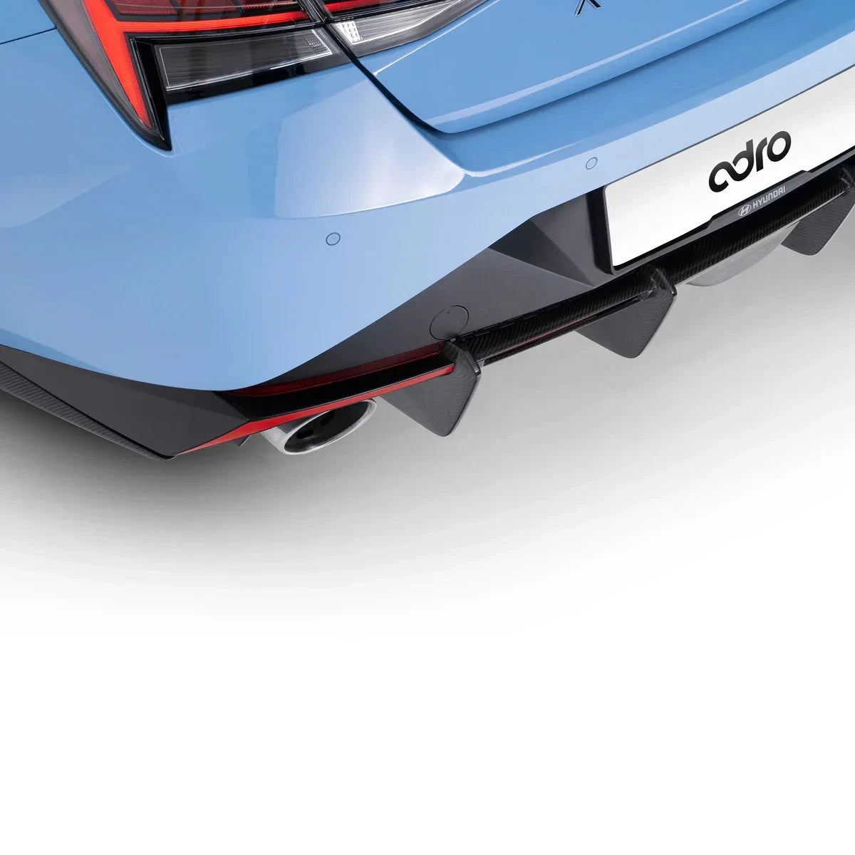 ADRO Carbon Fiber Rear Diffuser for Hyundai Elantra N, close-up installed view showing diffuser and exhaust details.
