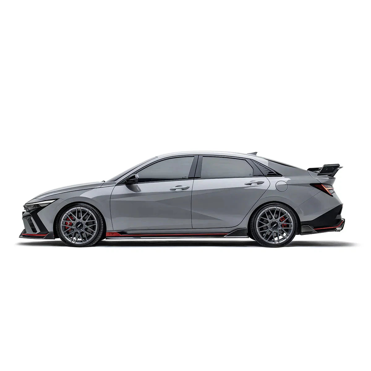 ADRO carbon aero parts on HYUNDAI ELANTRA N PE, side view showing black wheels, rear spoiler, and red accents.