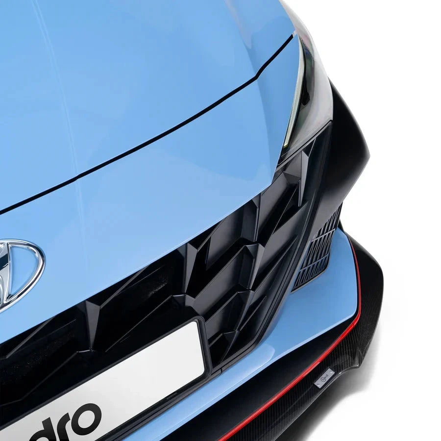 ADRO Carbon Fiber Front Lip on Hyundai Elantra N, close-up view showing front lip, grille, and headlight.