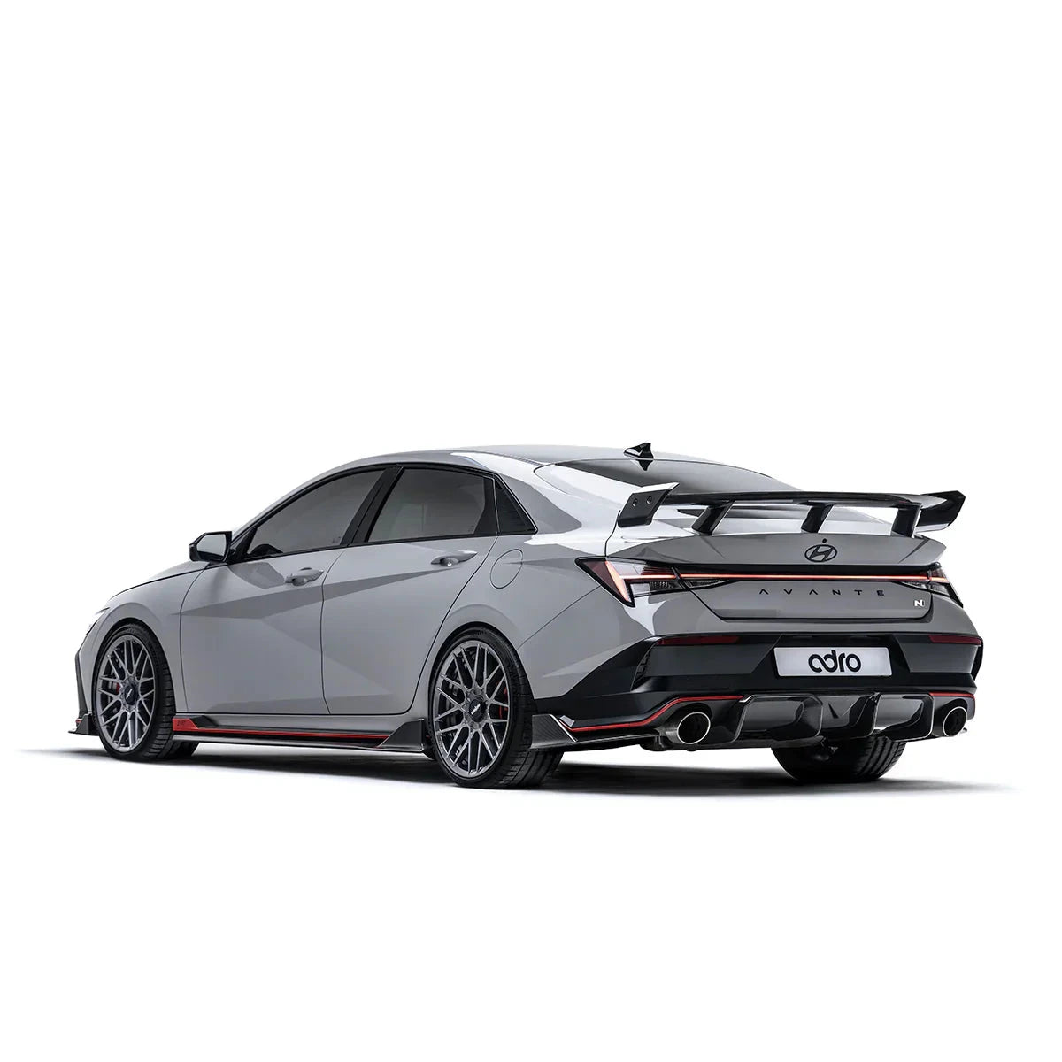 Carbon fiber rear spoiler on a gray coupe, angled rear view