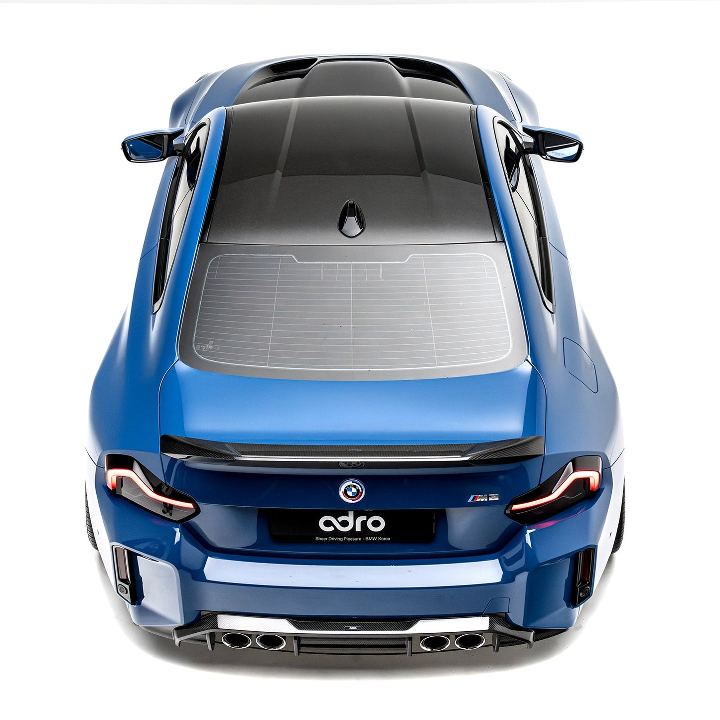 Centered rear view of carbon-look rear diffuser with vented grille and exhaust