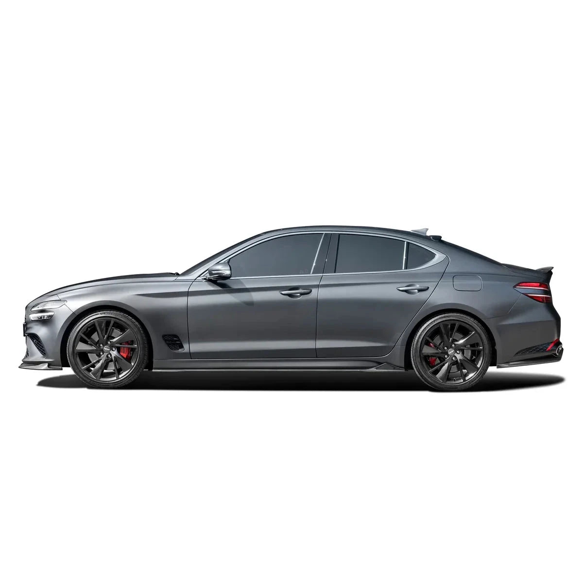 Carbon fiber rear diffuser on Genesis G70, black textured trim, side rear view