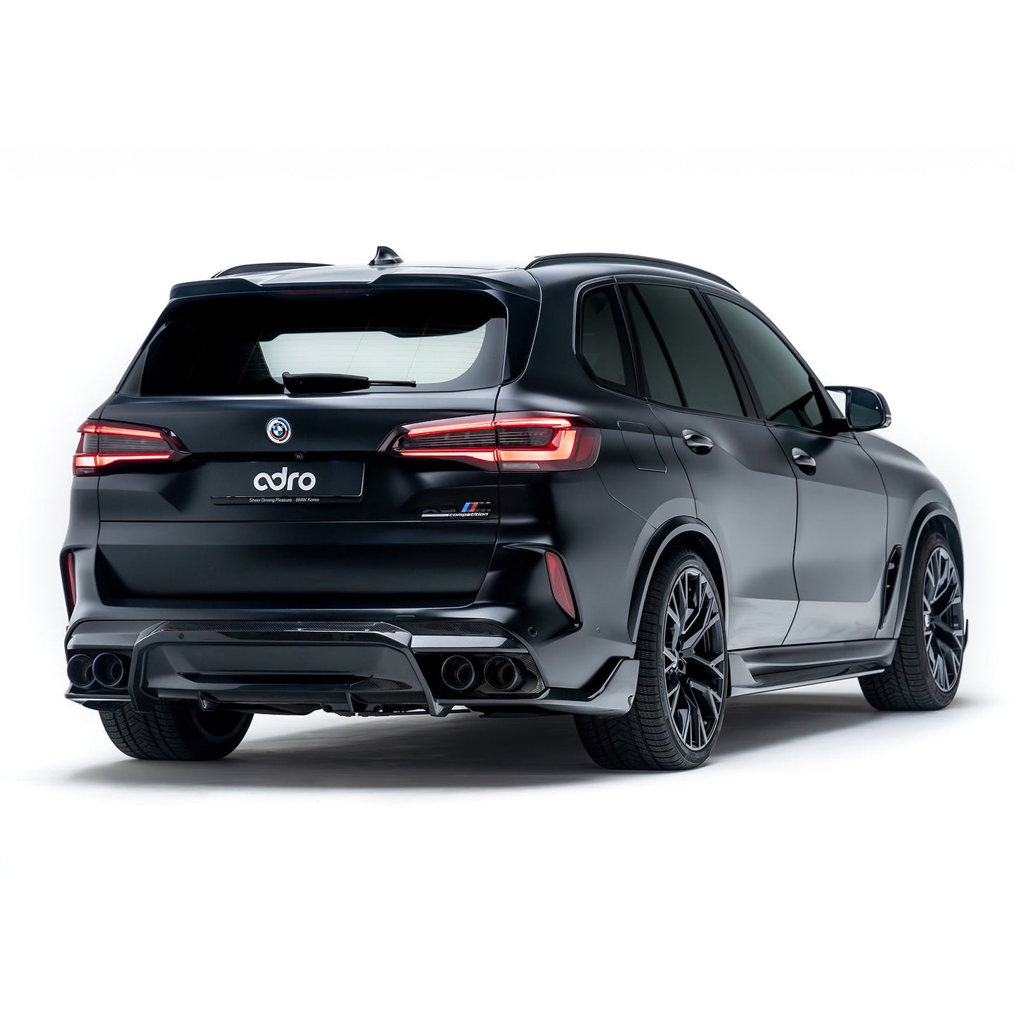 Carbon-fiber rear diffuser with angular side fins and twin exhaust outlets