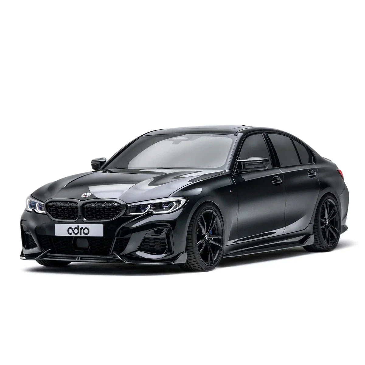 ADRO carbon fiber front lip for BMW G20 M340i, front-left view on white background.