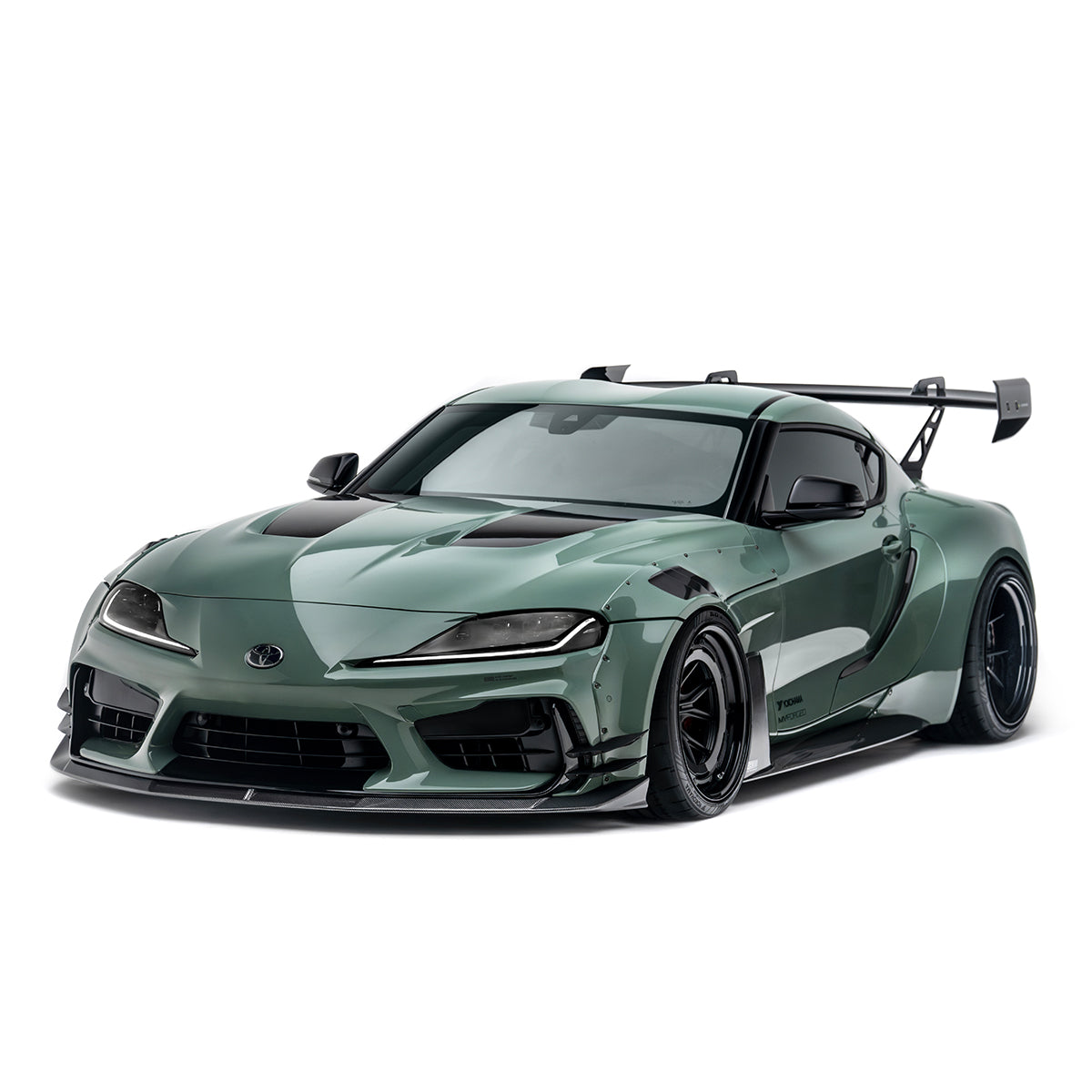 Green sports coupe front 3/4 view with widebody kit, hood vents, and rear wing