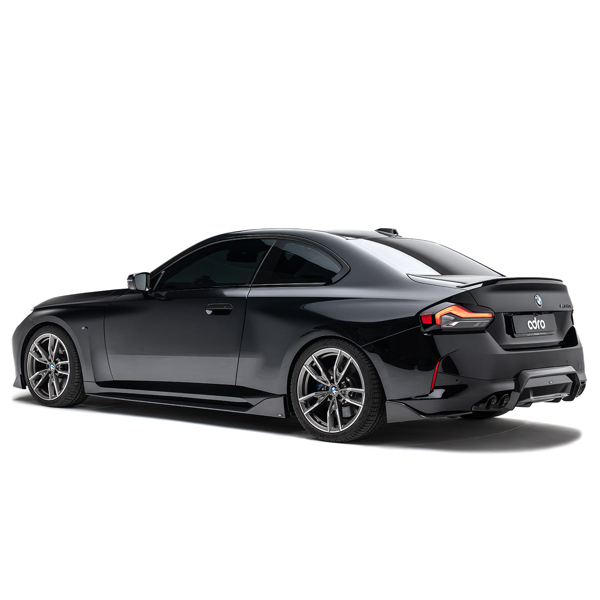 Carbon fiber rear diffuser surround with integrated fins near the bumper