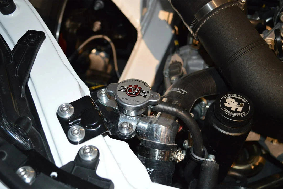 Radiator cap and aluminum filler neck installed in engine bay with CSF logo