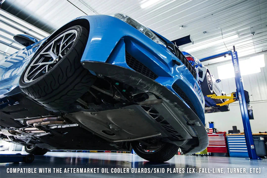Oil cooler installed on blue performance car underbody, showing black radiator section