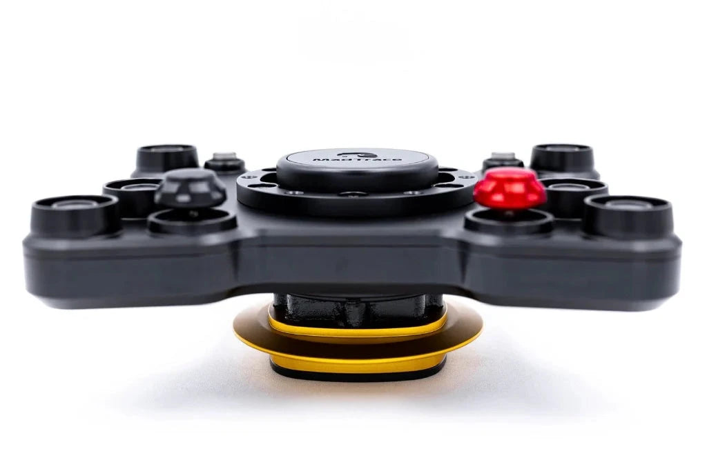Steering wheel adapter with black base, mounting tabs, and red release button