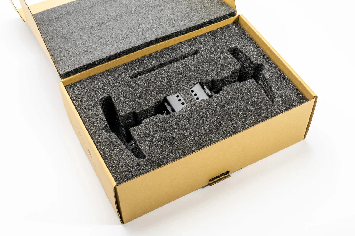 Magnetic paddle shifter kit laid in foam insert inside cardboard packaging