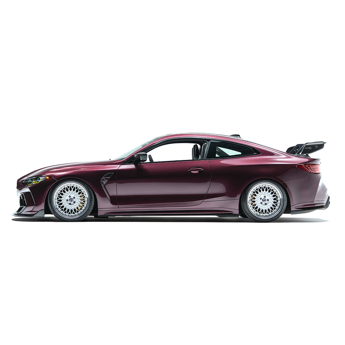 Side view of front bumper with grille mesh and front splitter, metallic magenta