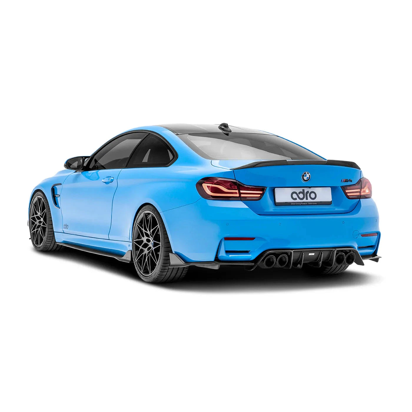 ADRO carbon fiber fender covers on BMW G8X M4, rear left view. Black wheels, blue exterior.