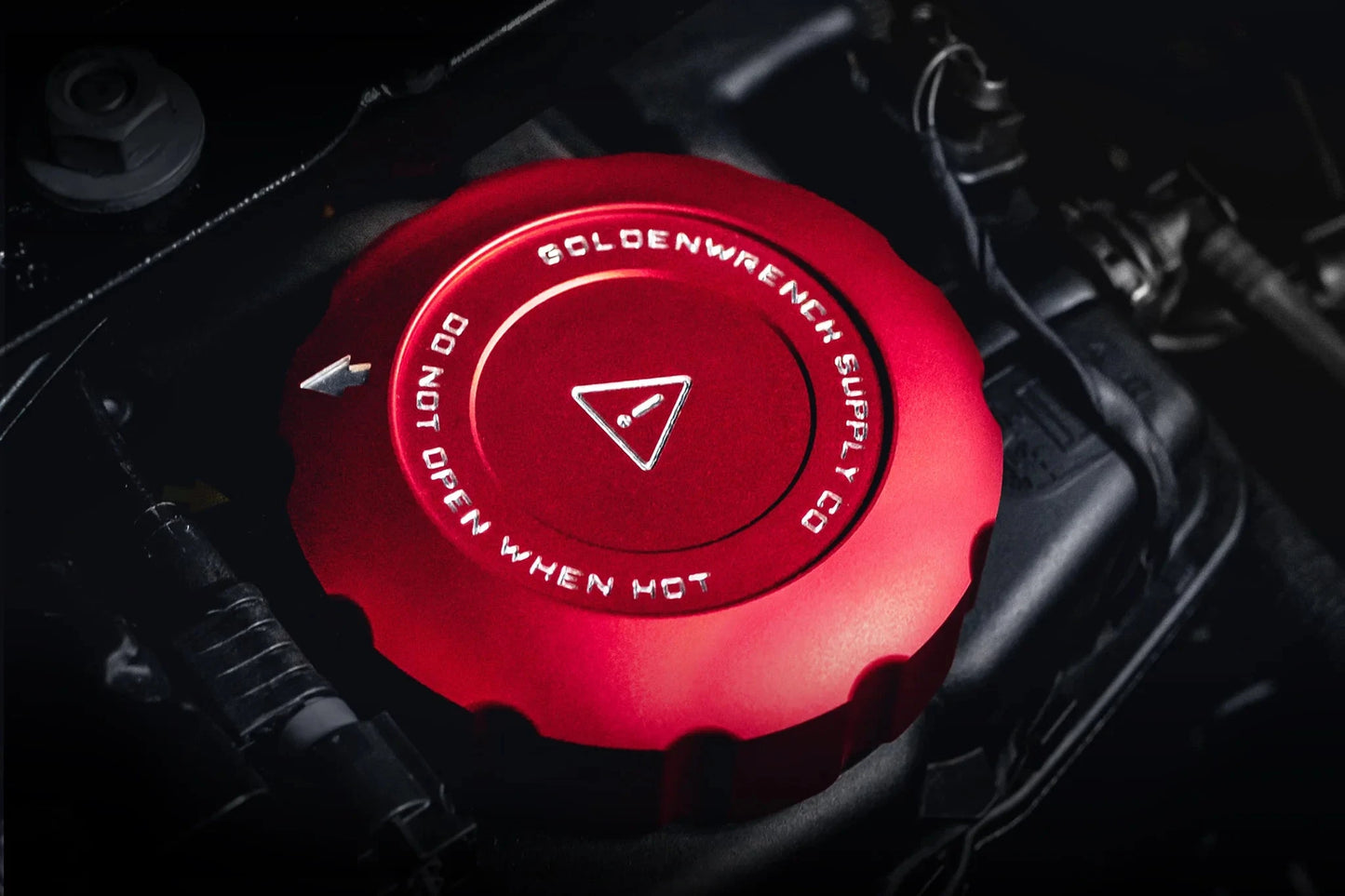 Engine oil cap, red anodized with warning triangle and circular lettering
