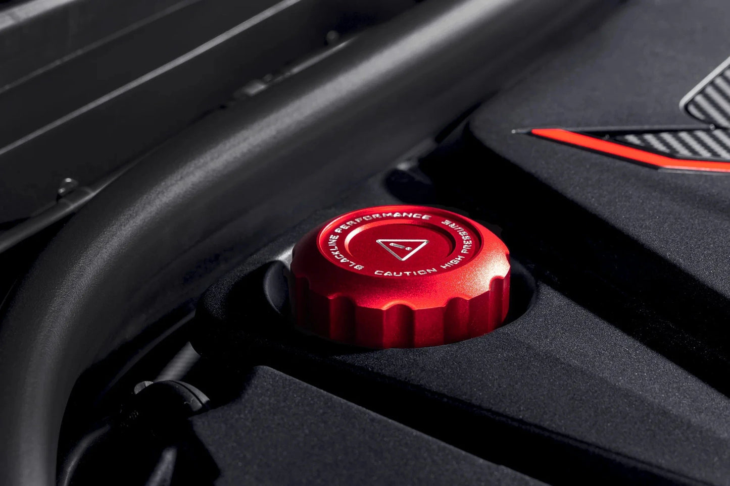 Red engine fluid cap installed on the engine cover