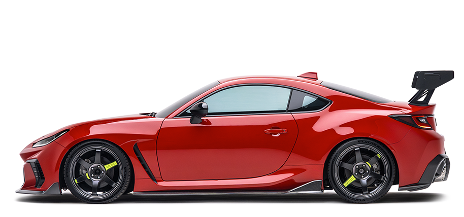 Red sports coupe, side profile with black wheels and rear spoiler