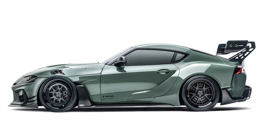 Green widebody sports coupe with black wheels and front splitter, side view.