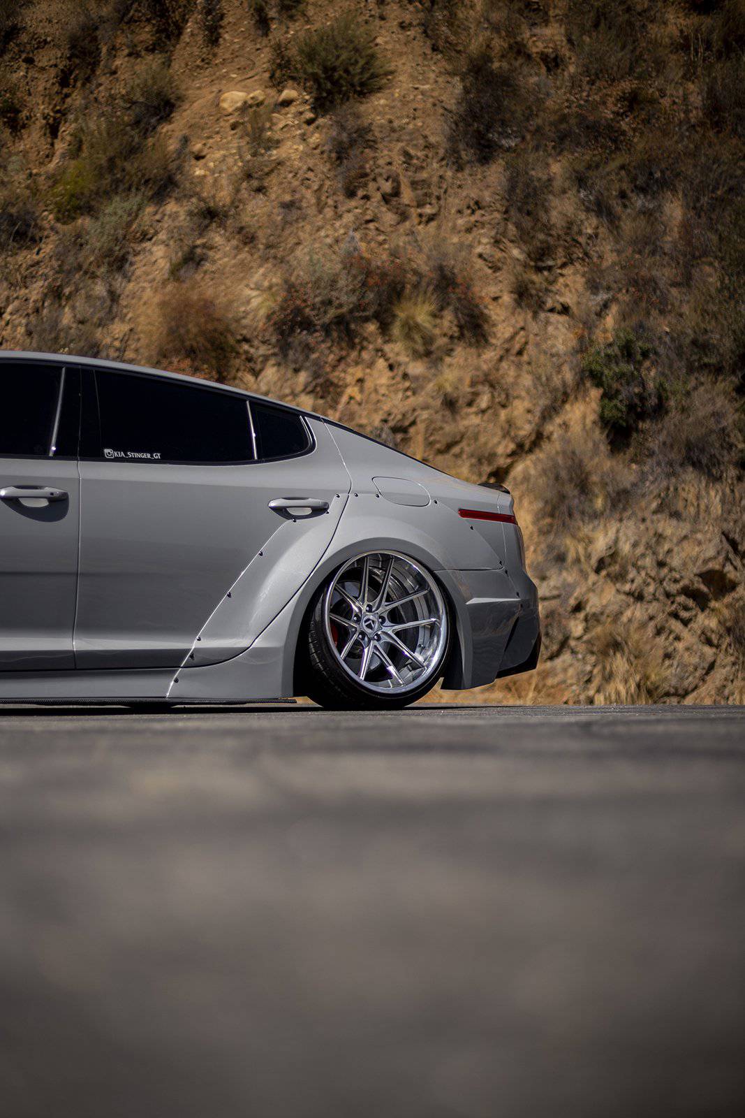 KIA Stinger widebody rear quarter panel and wheel with chrome multi-spoke rims