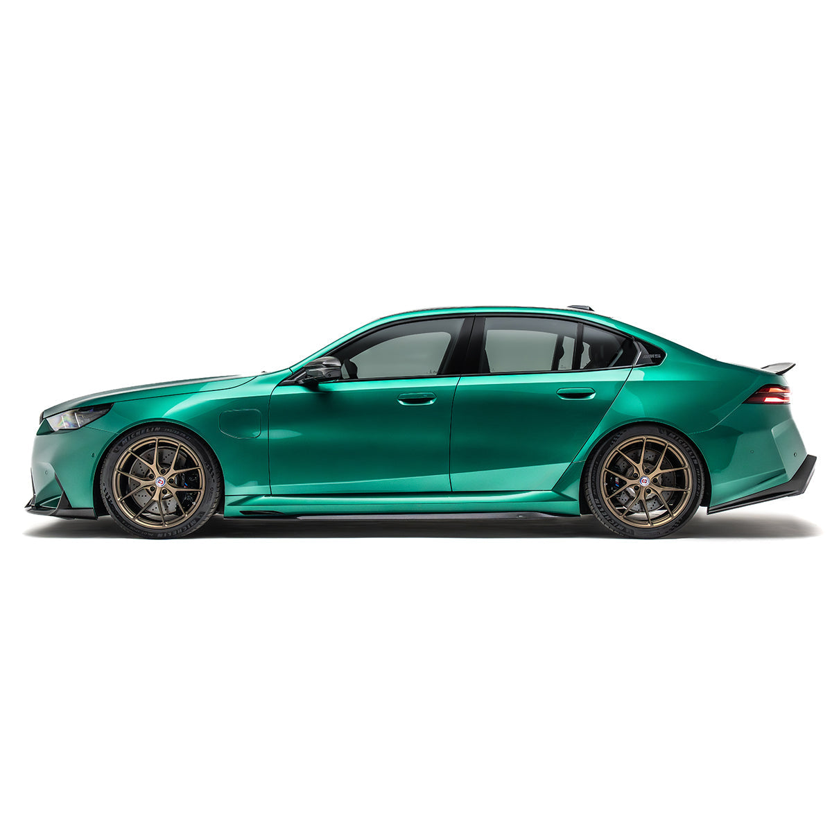 Front lip spoiler with black carbon-fiber accents on a green side-profile front bumper