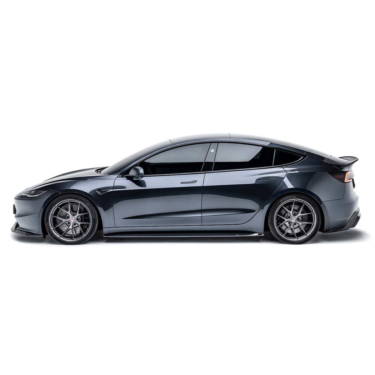 Carbon fiber rear diffuser on Tesla Model 3, visible at lower rear bumper