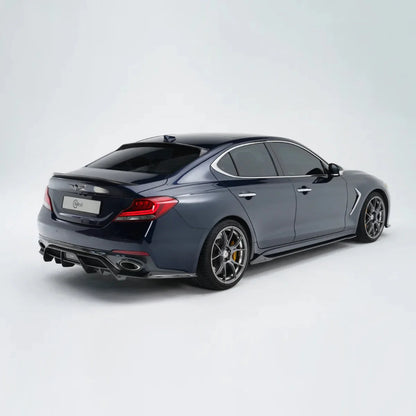 Dark gray performance sedan rear three-quarter view with alloy wheels and dual exhaust