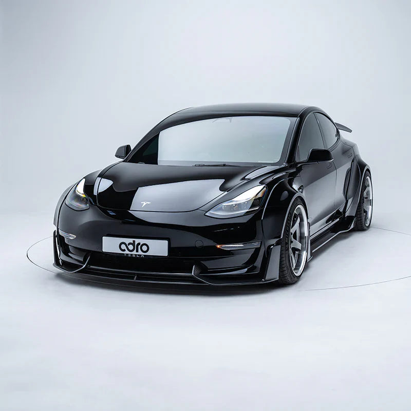 ADRO Tesla Model 3 Widebody carbon aero kit, studio shot, front three-quarter view on plain background.
