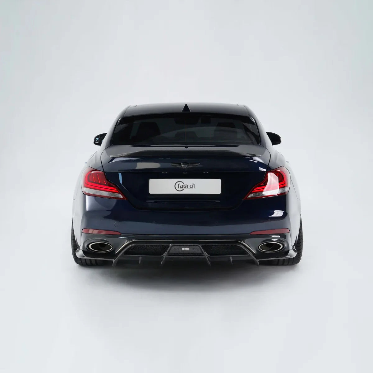 Blue performance sedan rear view with tail lights, diffuser, and dual exhaust tips
