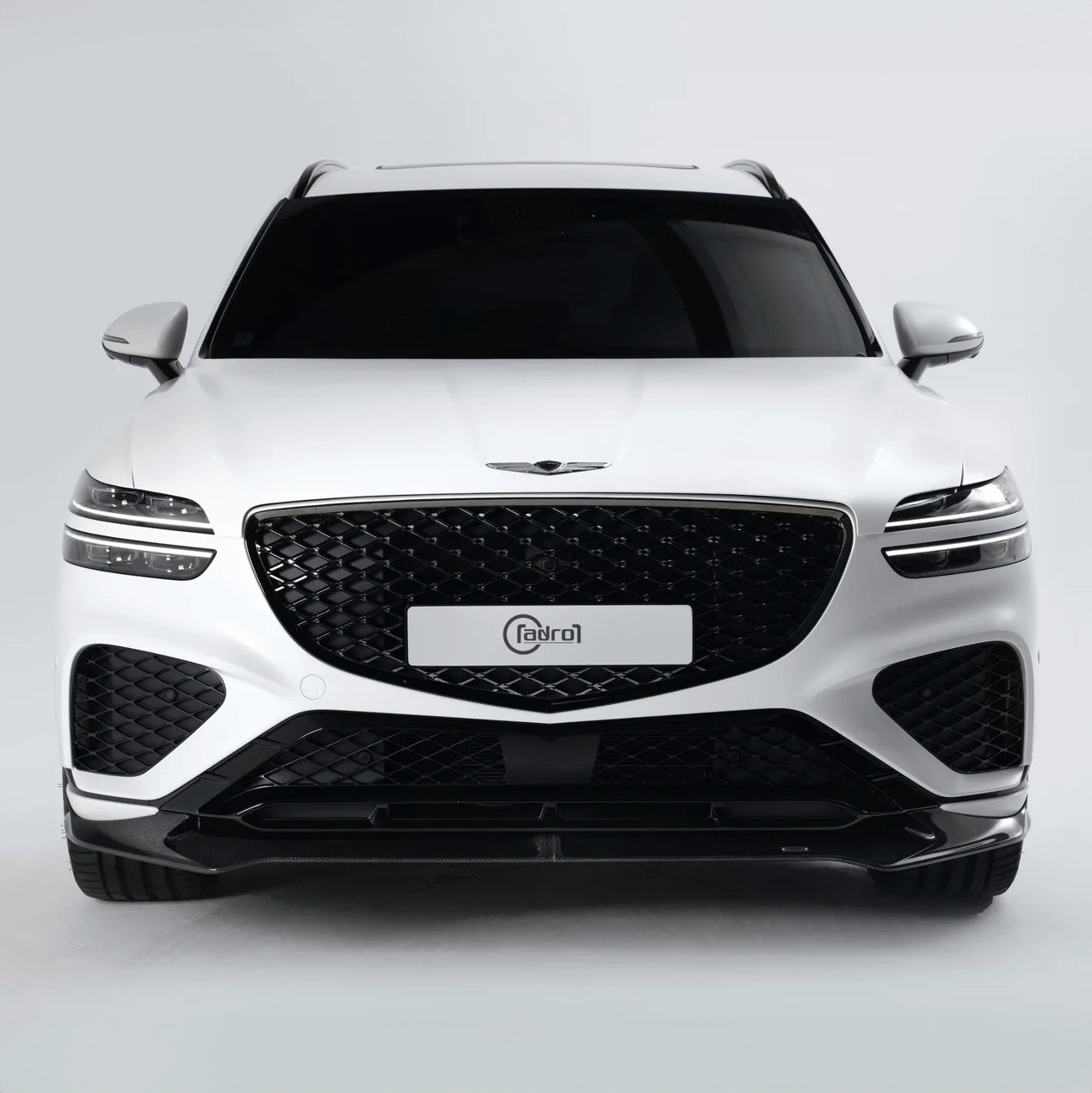 White SUV front view with black grille, LED headlights, dark lower bumper