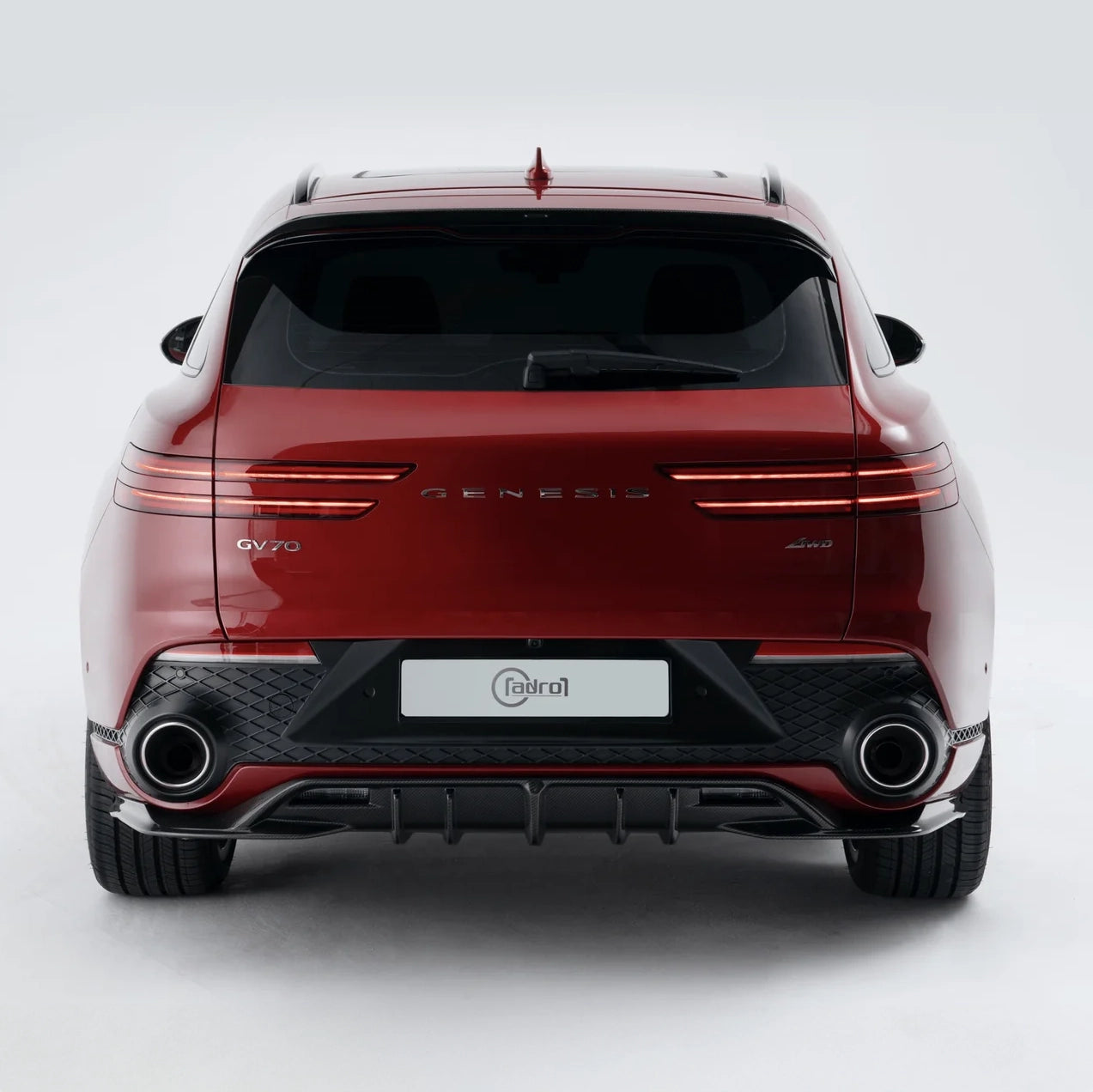 Red SUV rear view with dual exhaust outlets and black diffuser trim