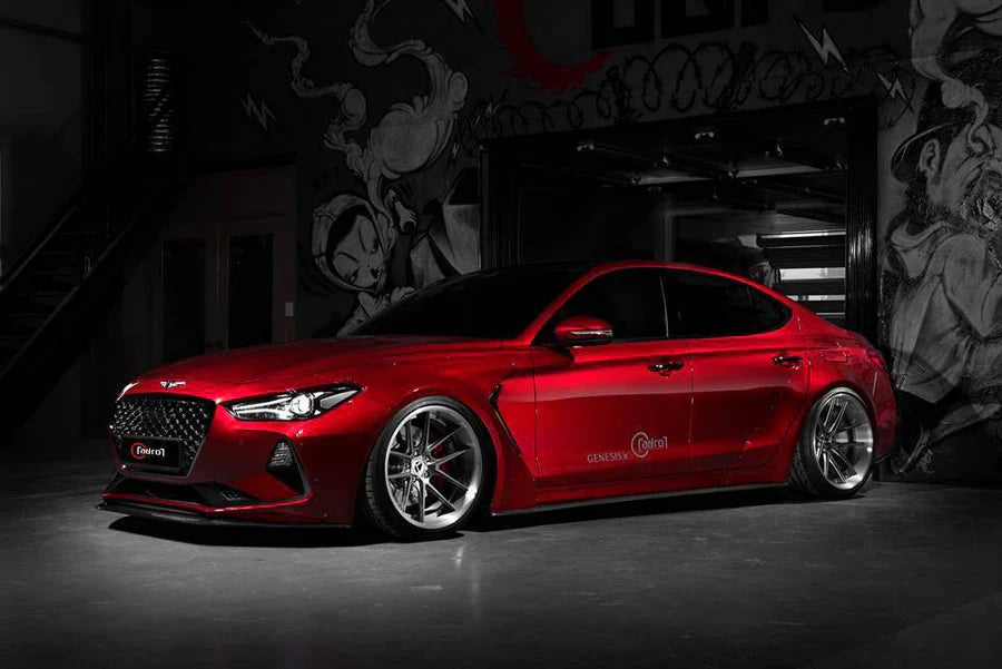Red performance sedan front-left three-quarter view with chrome wheels and grille