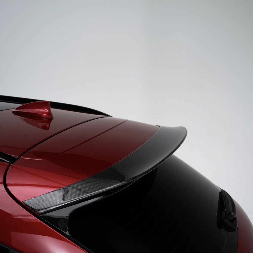 Red SUV rear spoiler and black trim, close-up of roof edge