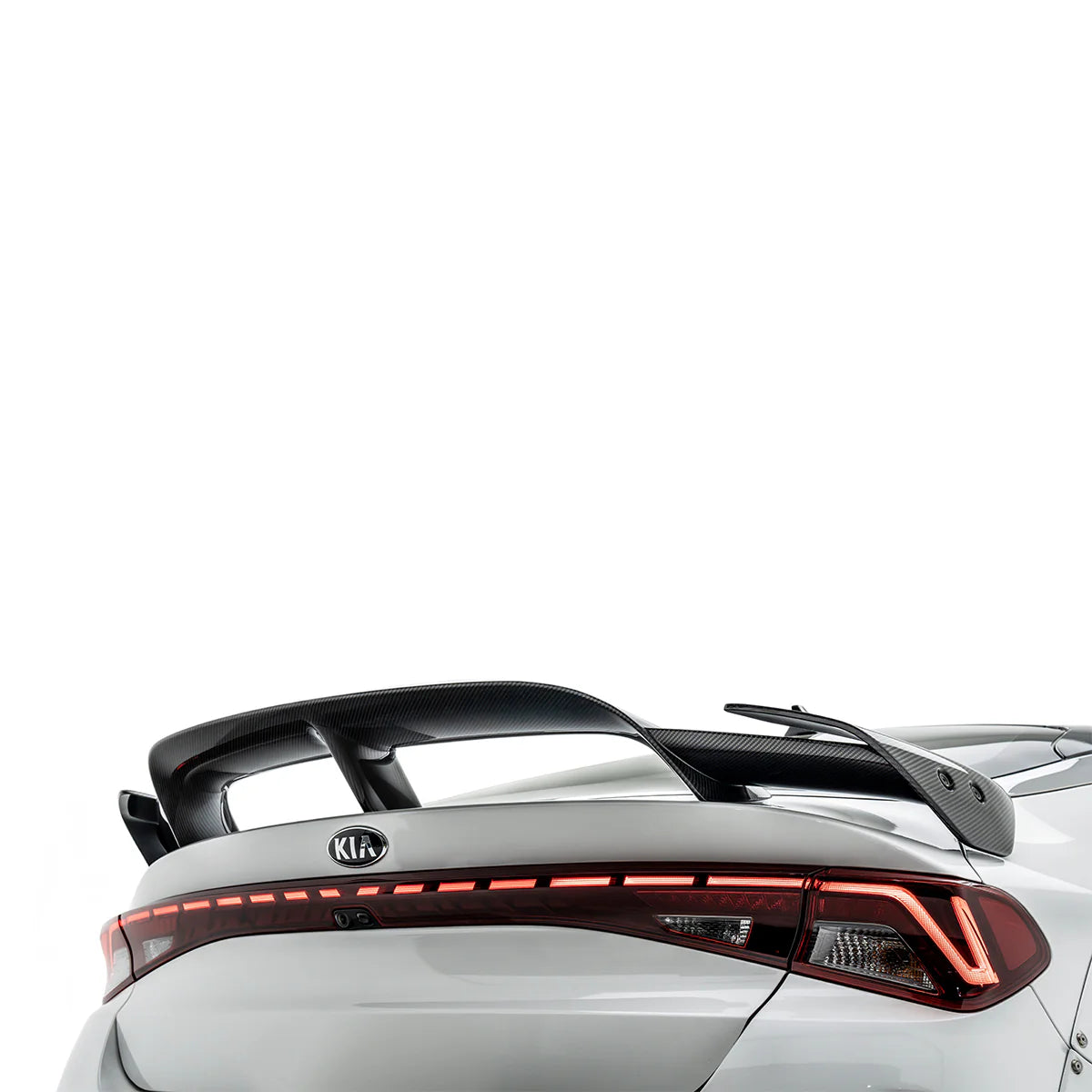 White sport sedan rear with illuminated taillight design and black spoiler
