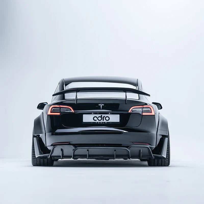 ADRO carbon fiber widebody kit and aero spoiler on Tesla Model 3, rear studio view.