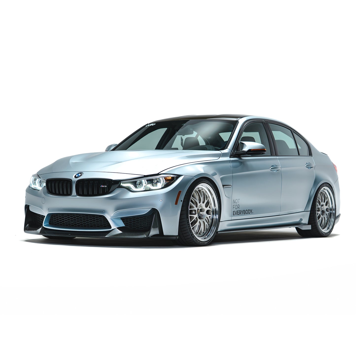 BMW front bumper lip spoiler in dark carbon fiber, front-left side view