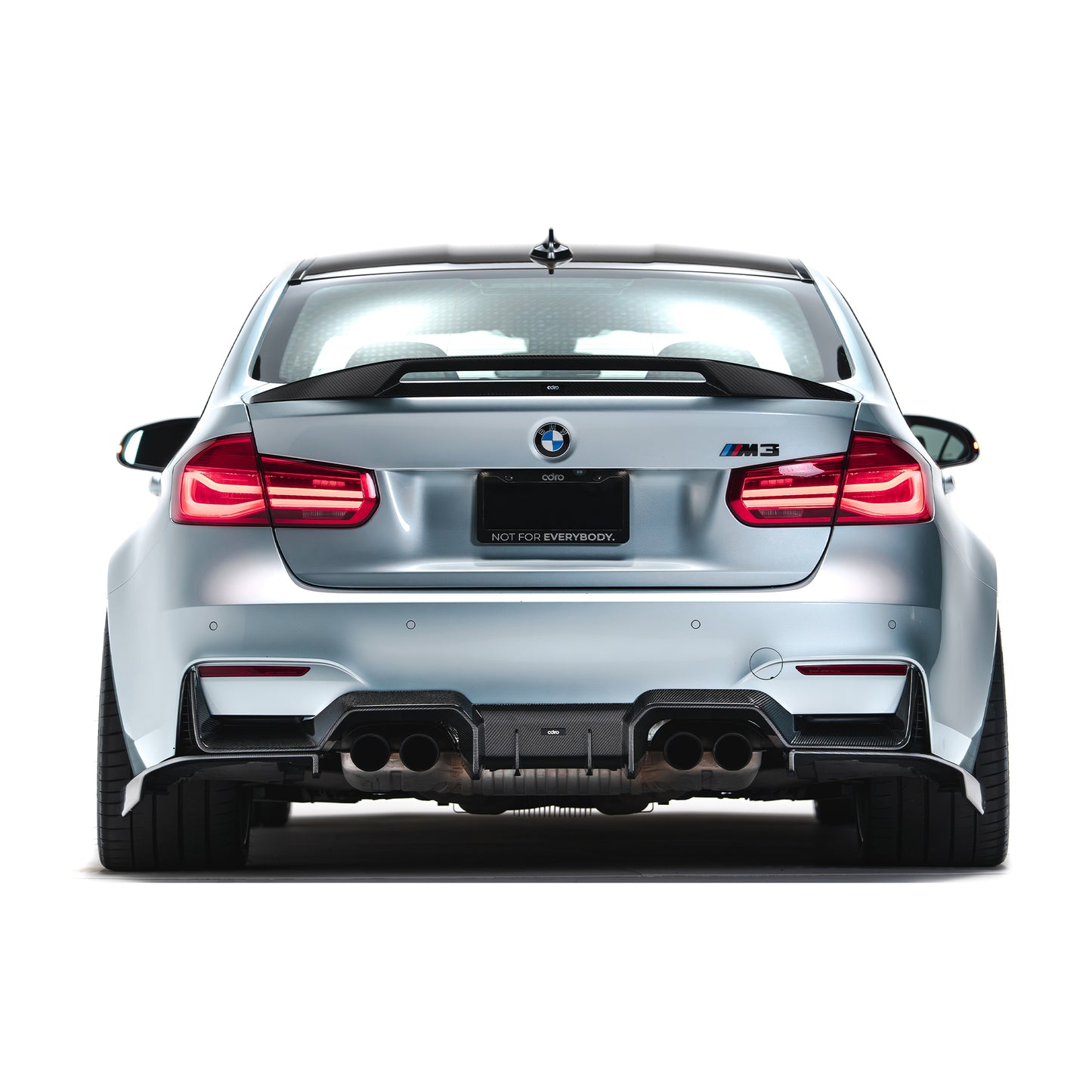 Rear carbon fiber trunk spoiler on a silver car