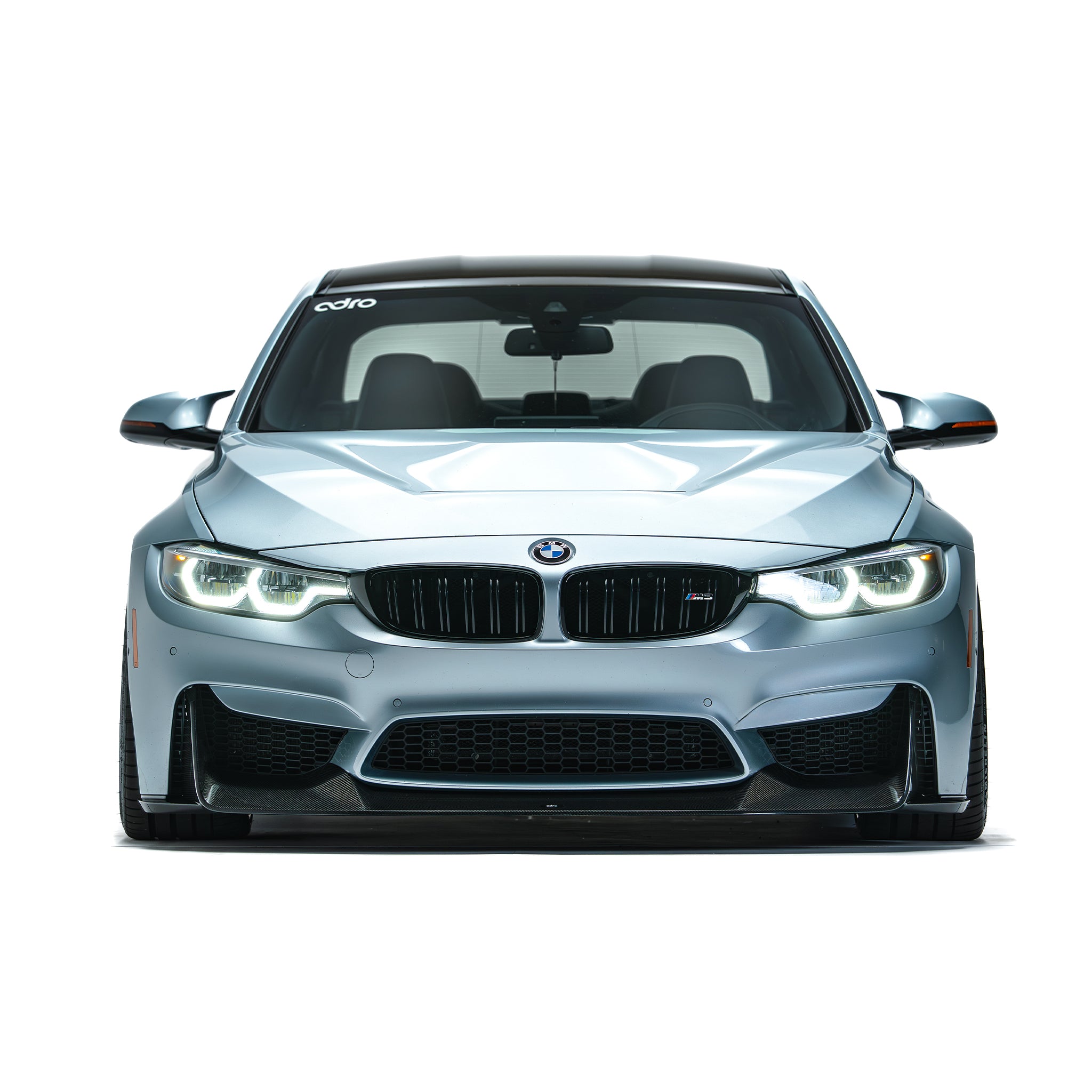BMW front bumper lip spoiler in dark carbon fiber, front view on silver car
