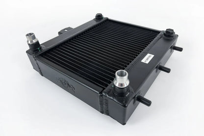 Auxiliary radiator with black fin core and hose fittings, matte black end tanks