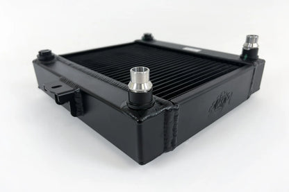 Auxiliary radiator with black fin pack, central hose connector and side mounting tabs