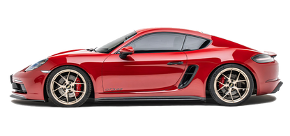 Red sports car with black side air vents and racing wheels, side profile.