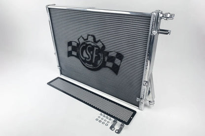Heat exchanger radiator with rock guard, inlet/outlet ports, and included hardware kit