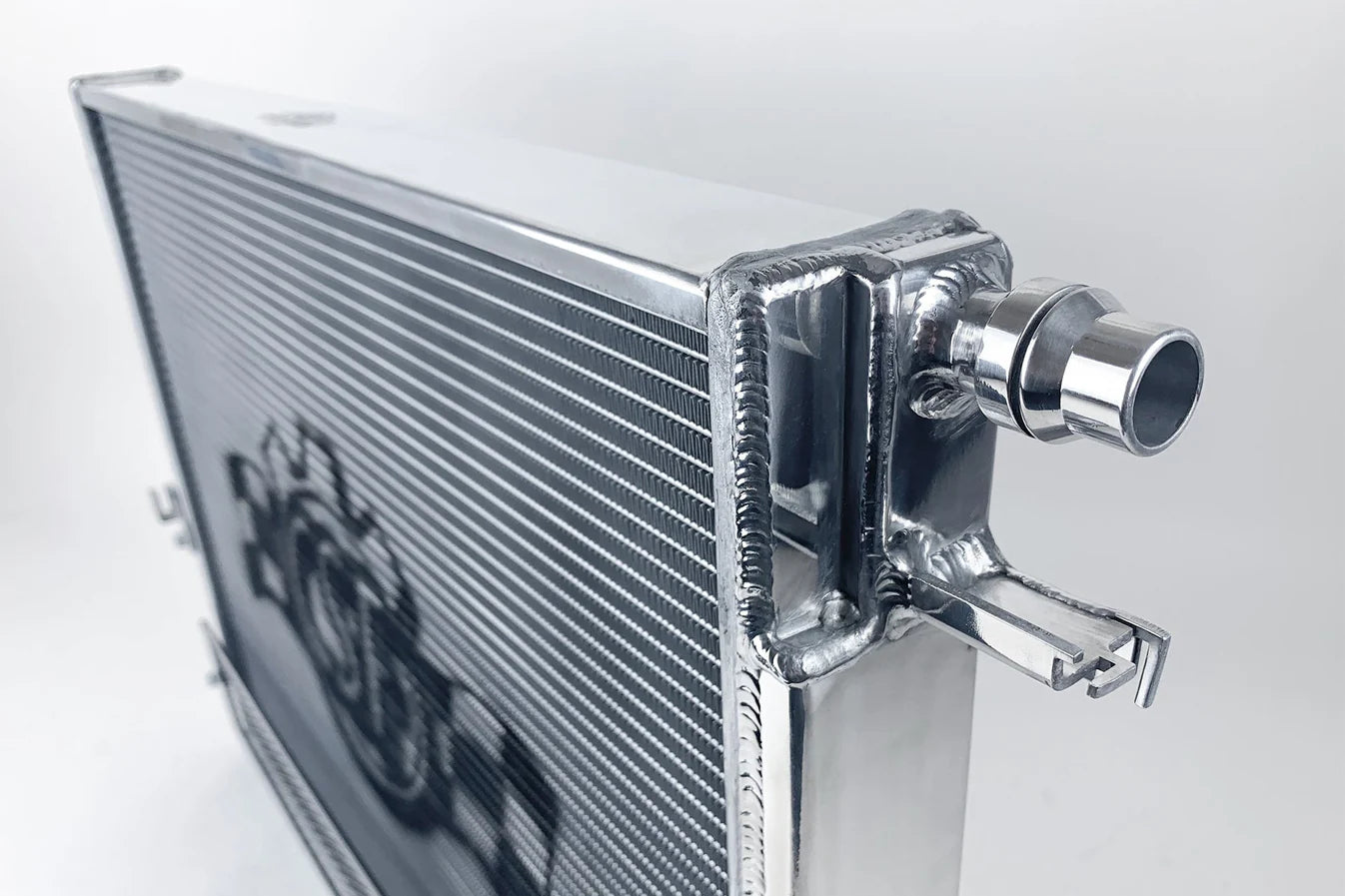 Heat exchanger radiator side view with polished end tank and inlet hose outlet
