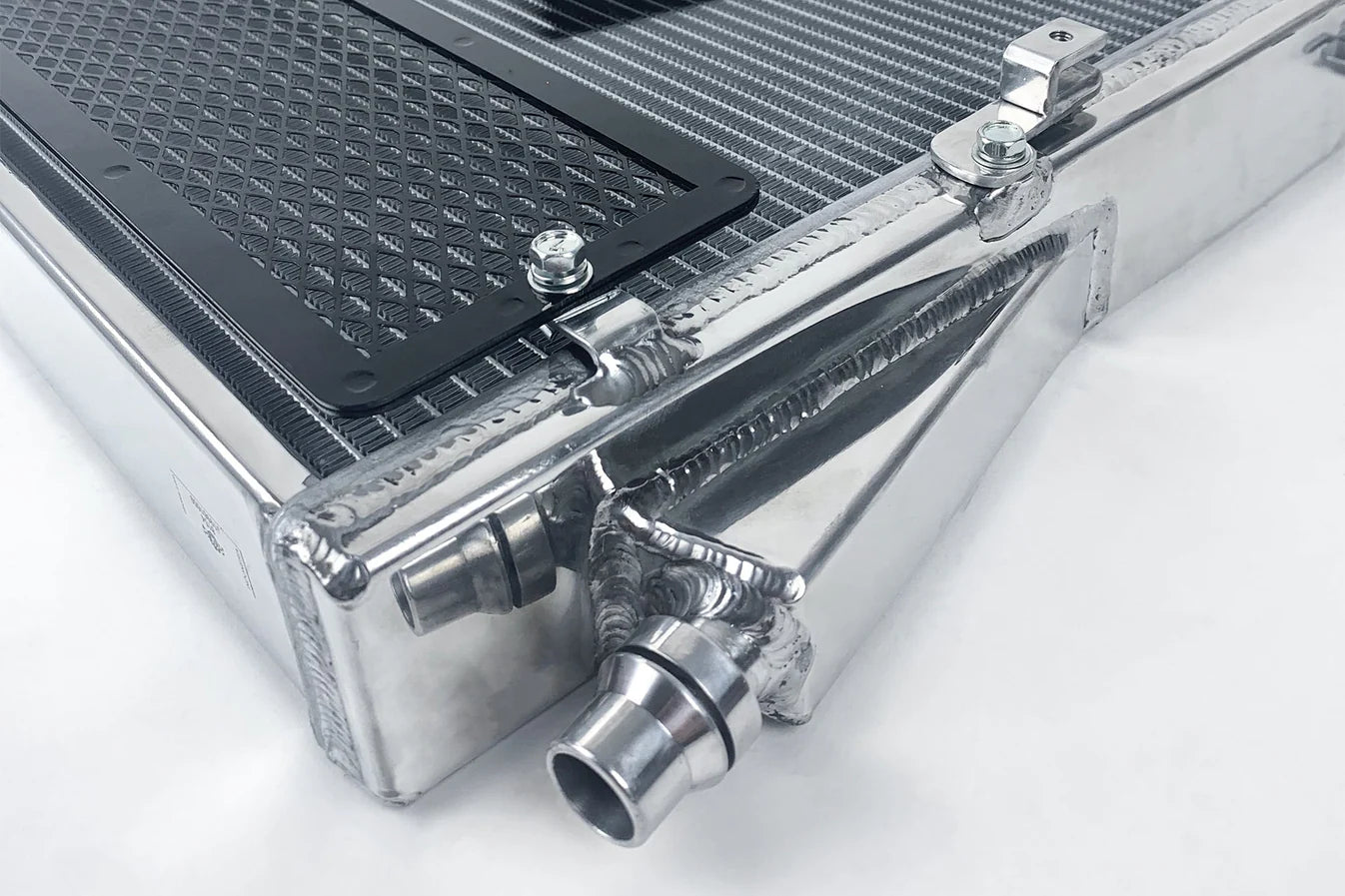 Heat exchanger radiator corner detail with rock guard mesh and metal fittings