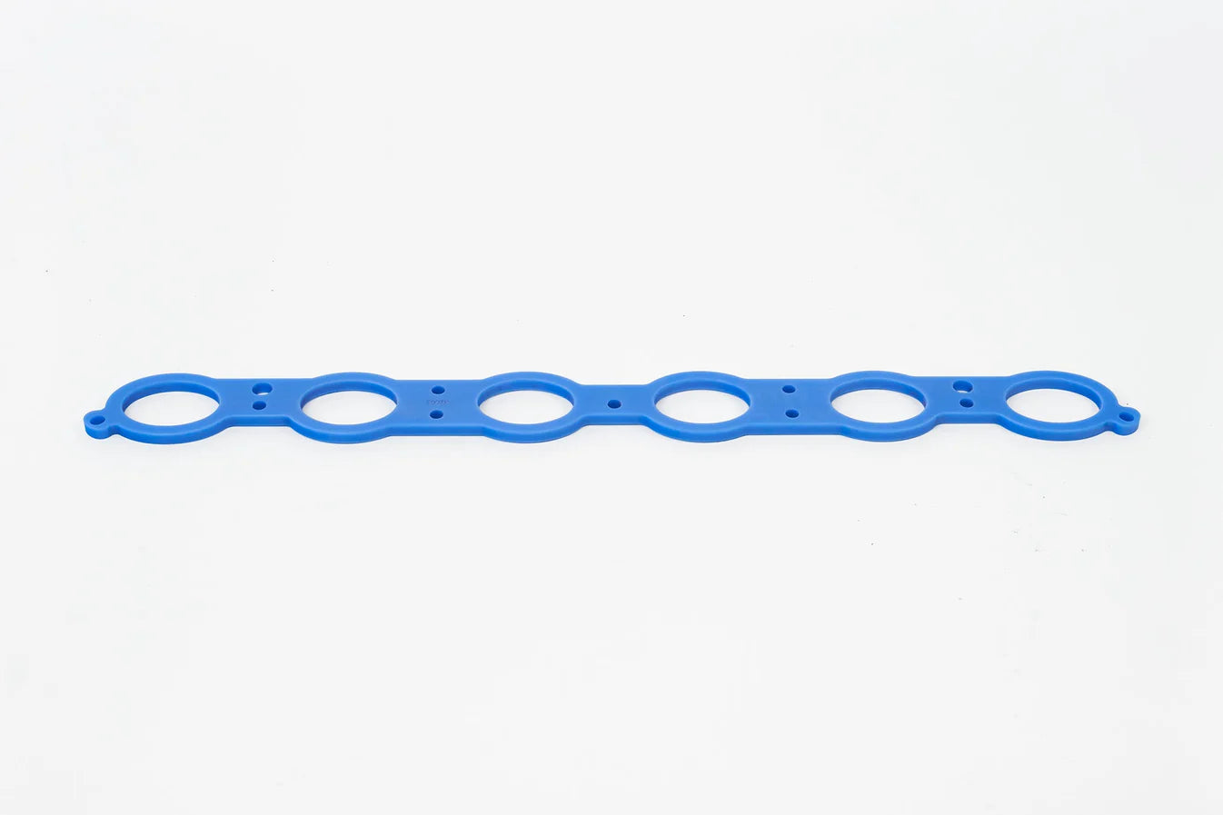 Blue manifold spacer gasket strip with multiple circular bolt holes