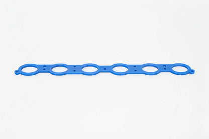 Blue manifold spacer gasket strip with multiple circular bolt holes